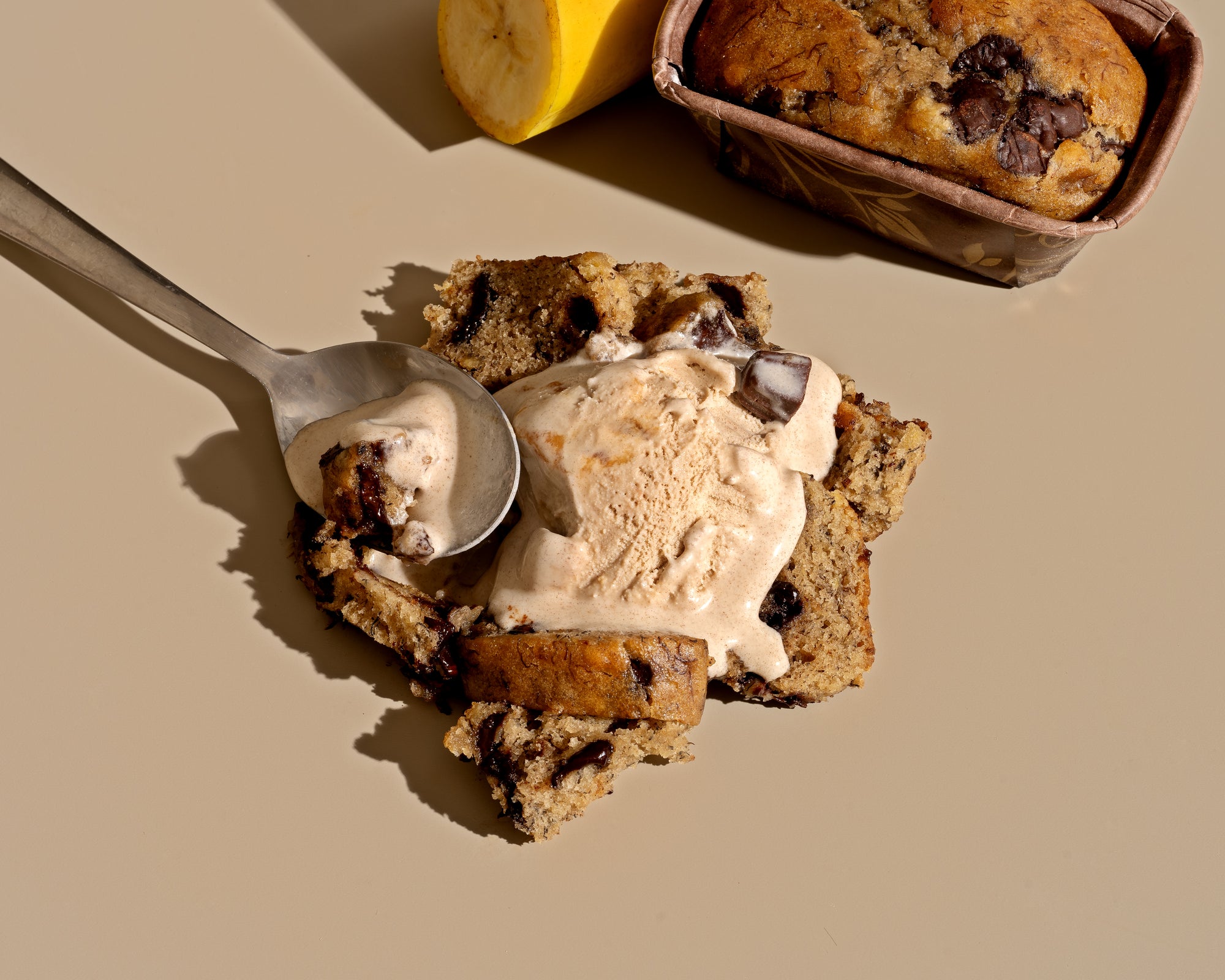 Slice of banana bread with a scoop of ice-cream on top of it